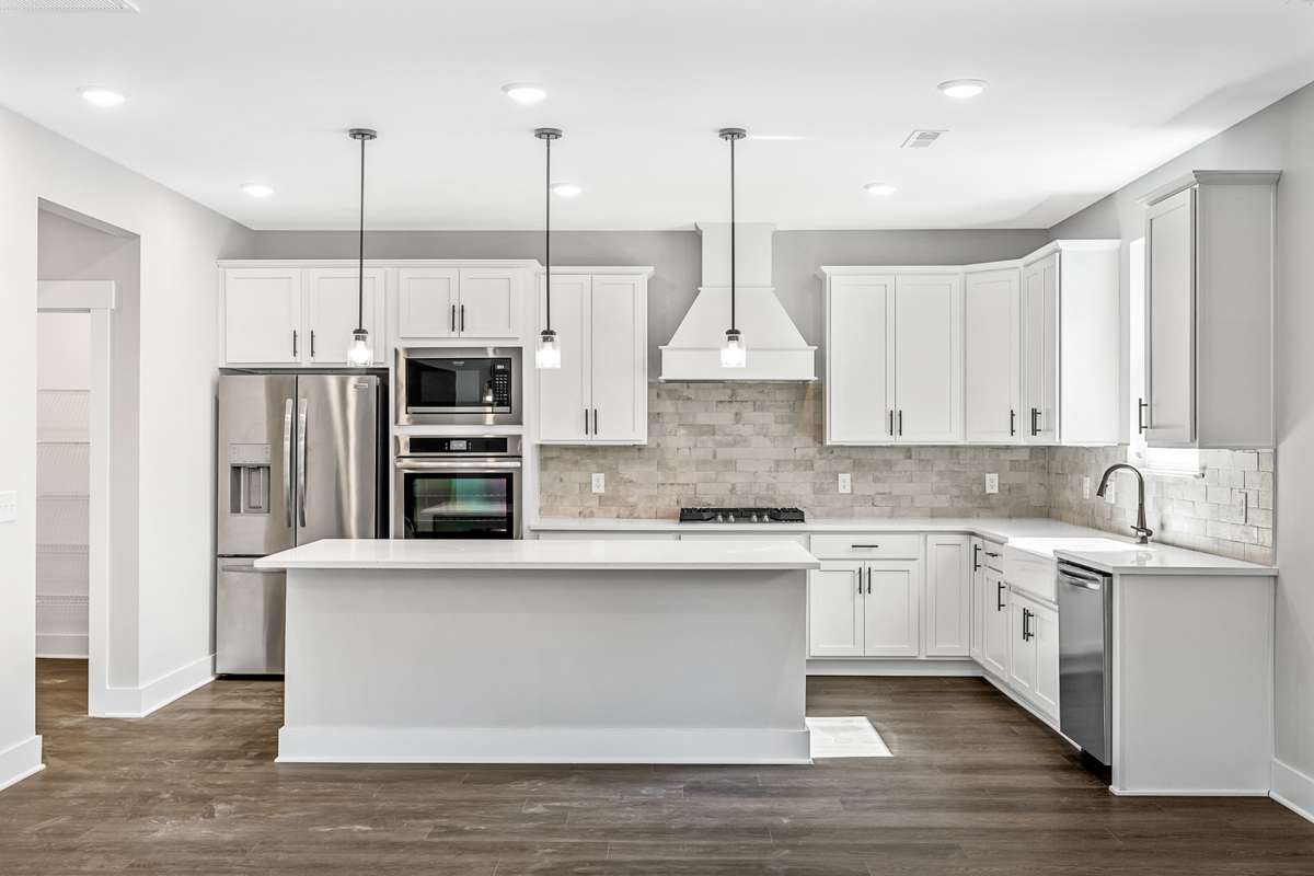 Model of the Henry floorplan.  Colors and selections may vary.  Gourmet kitchen with Hood and double ovens shown.  This option is available.