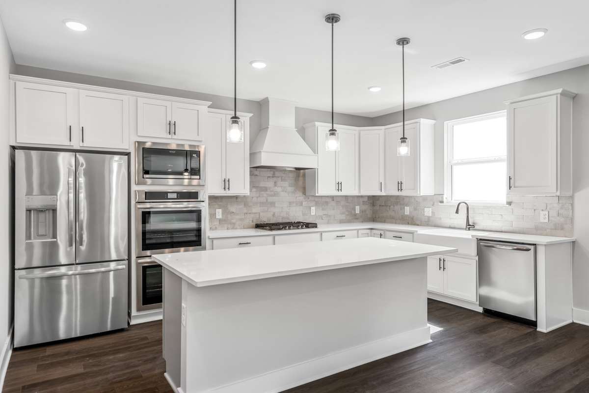 Model of the Henry floorplan.  Colors and selections may vary.  Gourmet kitchen with Hood and double ovens shown.  This option is available.