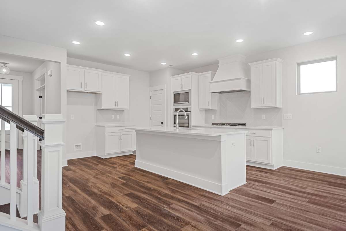 Picture of model home and not of actual home being built.   Home will have the gourmet kitchen setup like pictured with double ovens and hood vent.