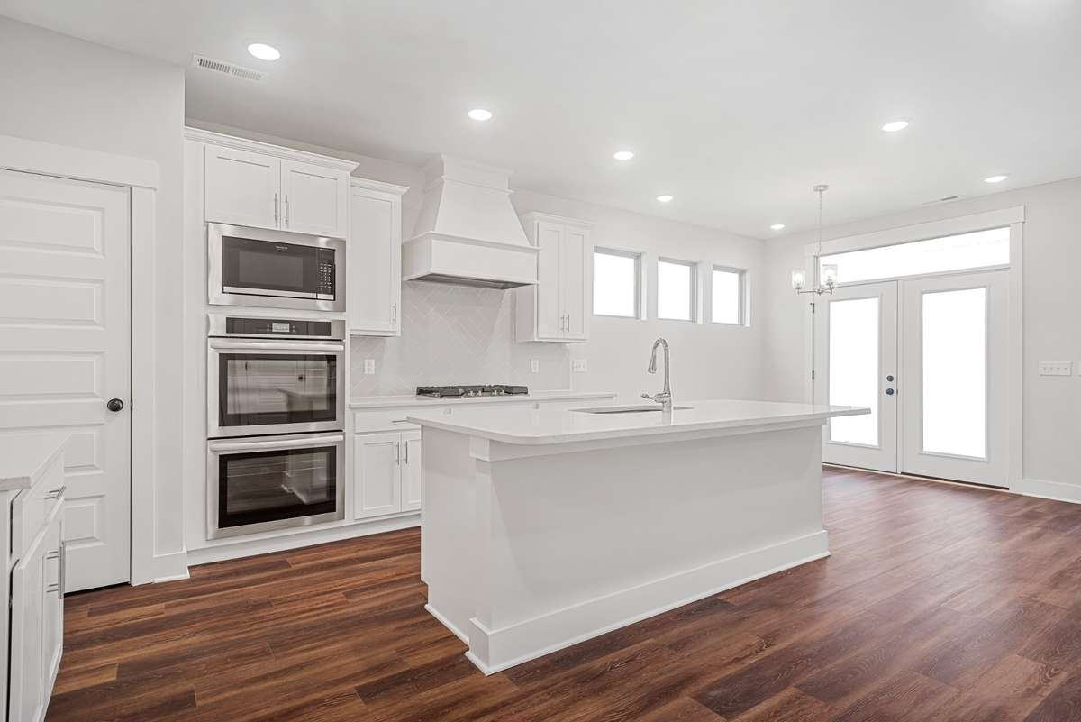 Picture of model home and not of actual home being built.   Home will have the gourmet kitchen setup like pictured with double ovens and hood vent.