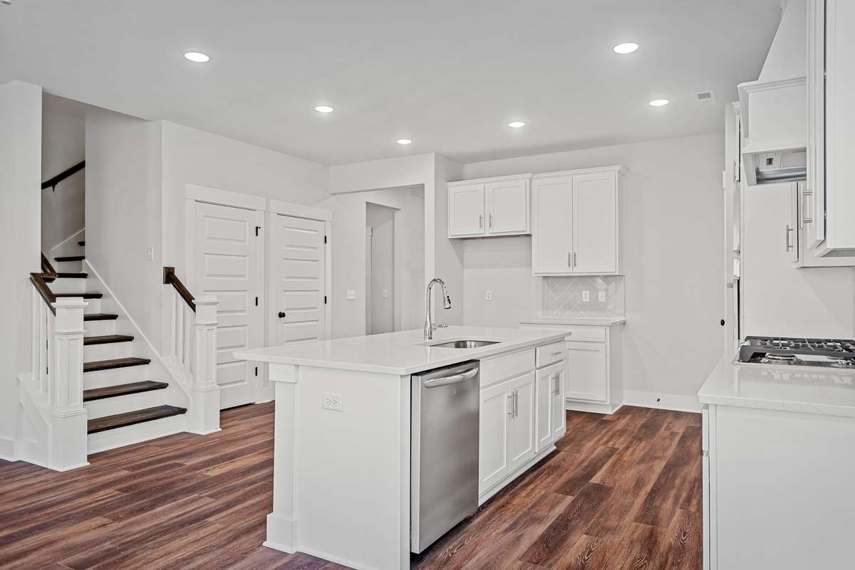 Picture of model home and not of actual home being built.   Home will have the gourmet kitchen setup like pictured with double ovens and hood vent.