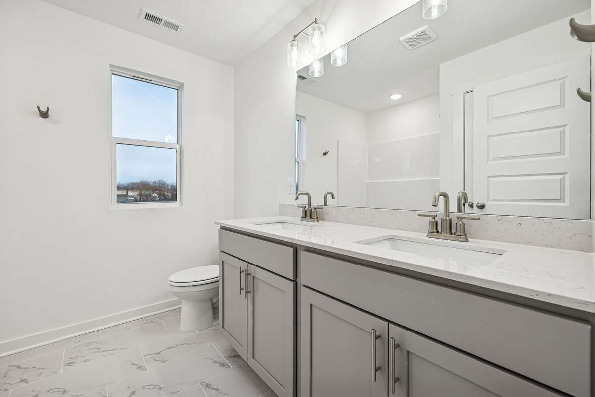 Picture of model home and not of actual home being built.  Dual sink vanity will be in this home with beautiful quartz countertops.