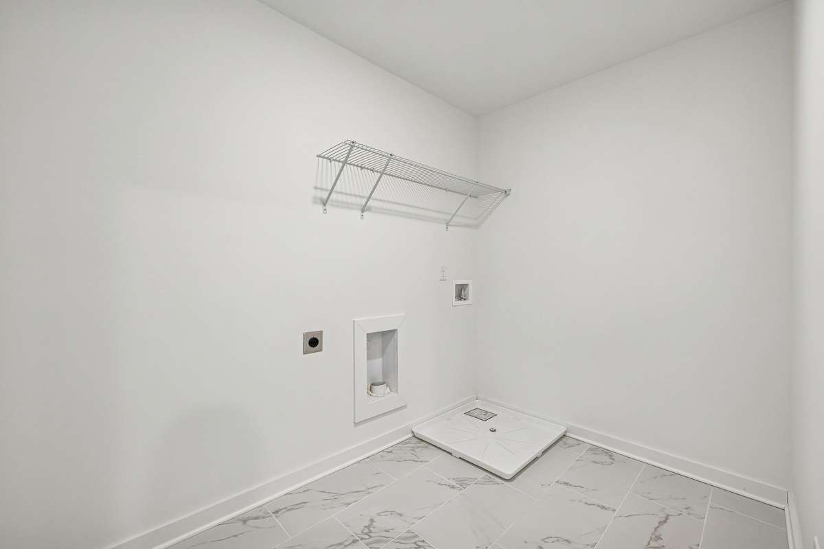 Picture of model home and not of actual home being built.  Oversized laundry room with tile flooring.