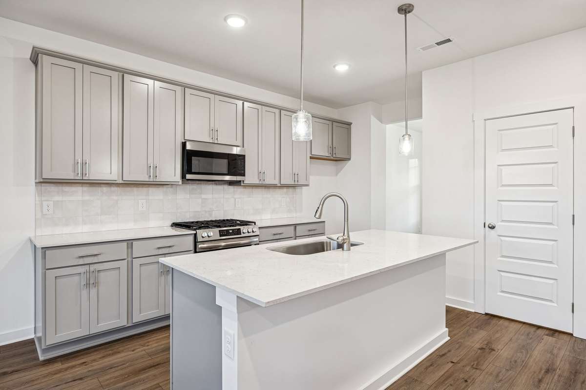 Picture of model home and not of actual home being built.  Cabinet colors for home is shown.