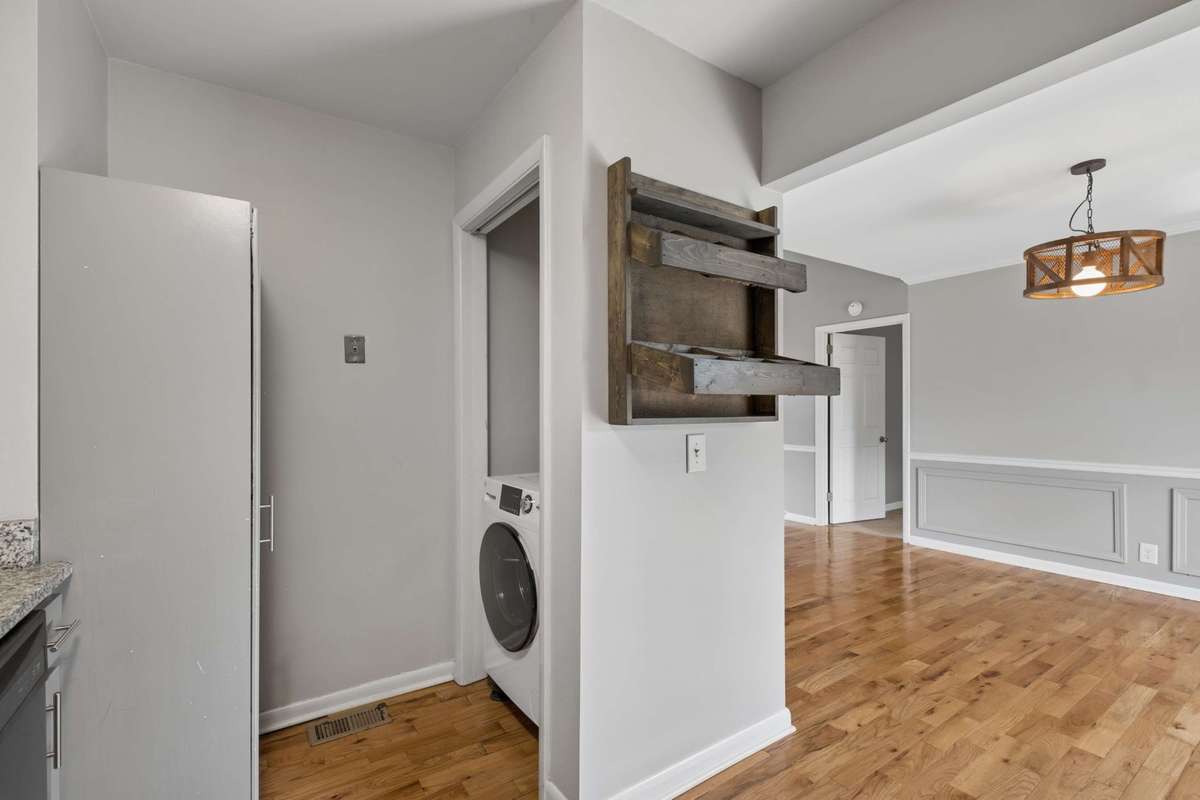 New combination washer/dryer unit/ opposite pantry closet. Additional hanging storage for grab-n-go fruit or other snacks!