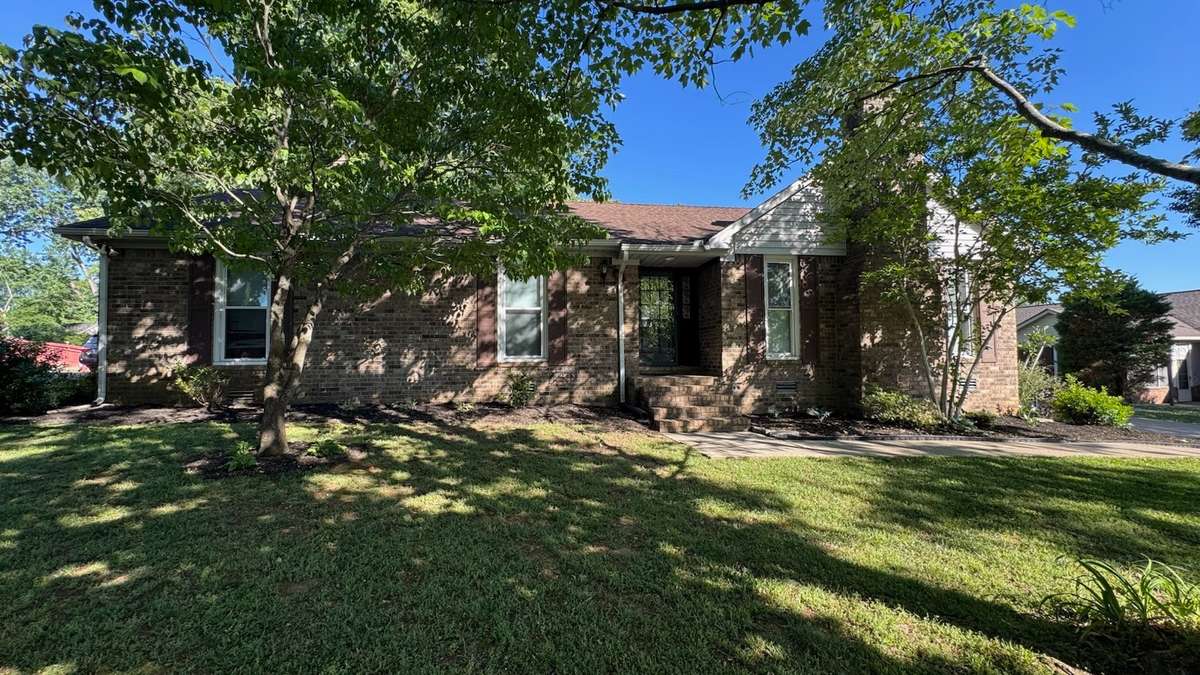 Front of property with beautiful trees and landscaping!