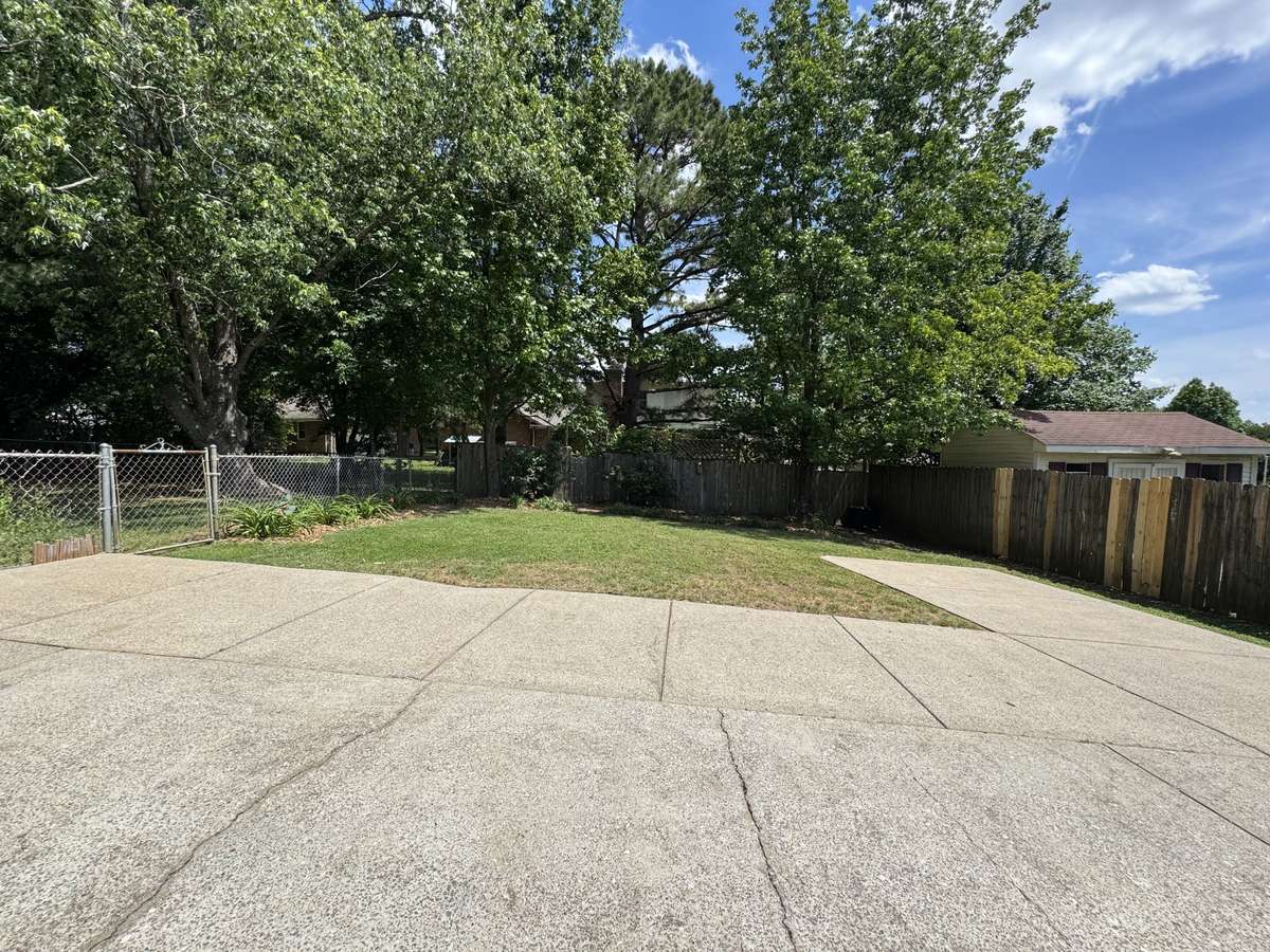 Large concrete pad leading into 2 car garage.  Ample parking area.