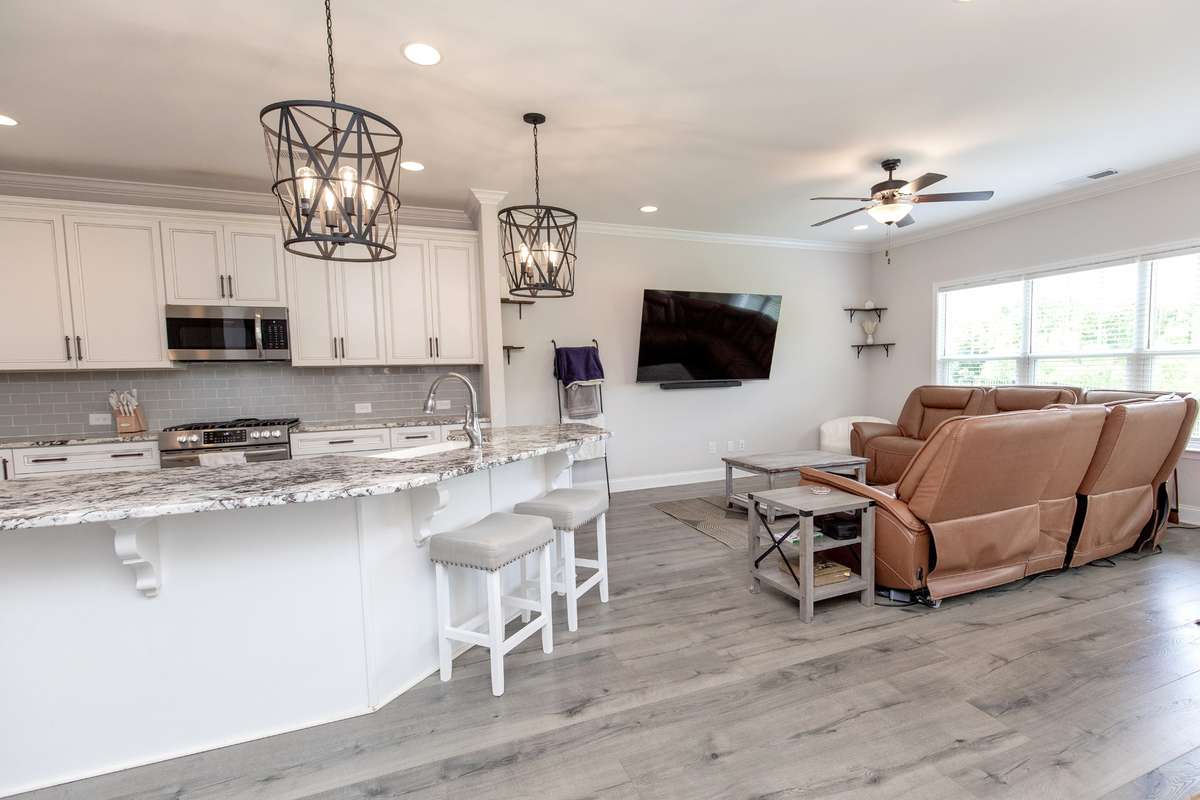 Lots of light fills this living area and has peaceful views of the woods outside