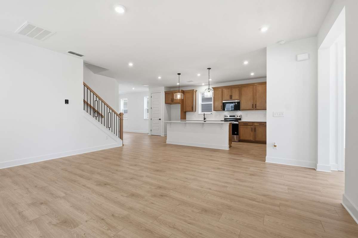Great room with electric fireplace open to the kitchen.