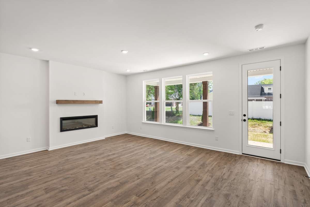 Family Room includes an electric fireplace with floating wood mantle. Outlets and media hookups are already on the wall above the fireplace, ready for a TV!