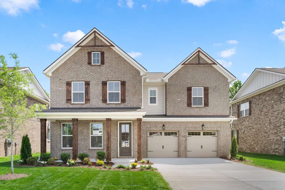 Stunning all-brick exterior with cedar posts and shutters.