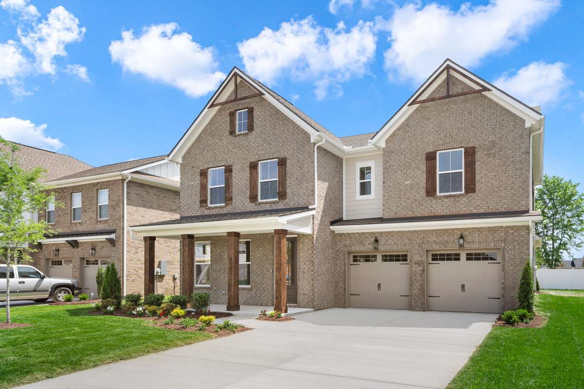 Carriage garage doors with driveway that easily fits 4 cars