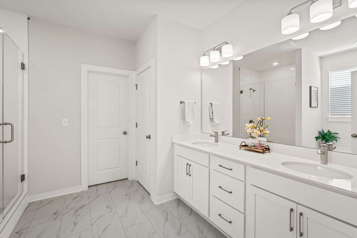 Primary Bath with tile floors, double vanity and quartz countertops, linen closet and separate water closet!
*Photo of a previously built Chelsey