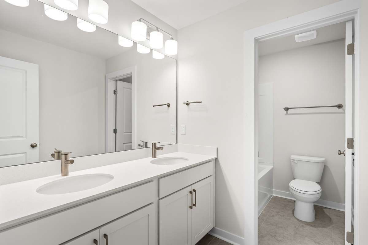 Hallway Bath with double vanity, quartz countertops and tile floor
*Photo of a previously built Chelsey