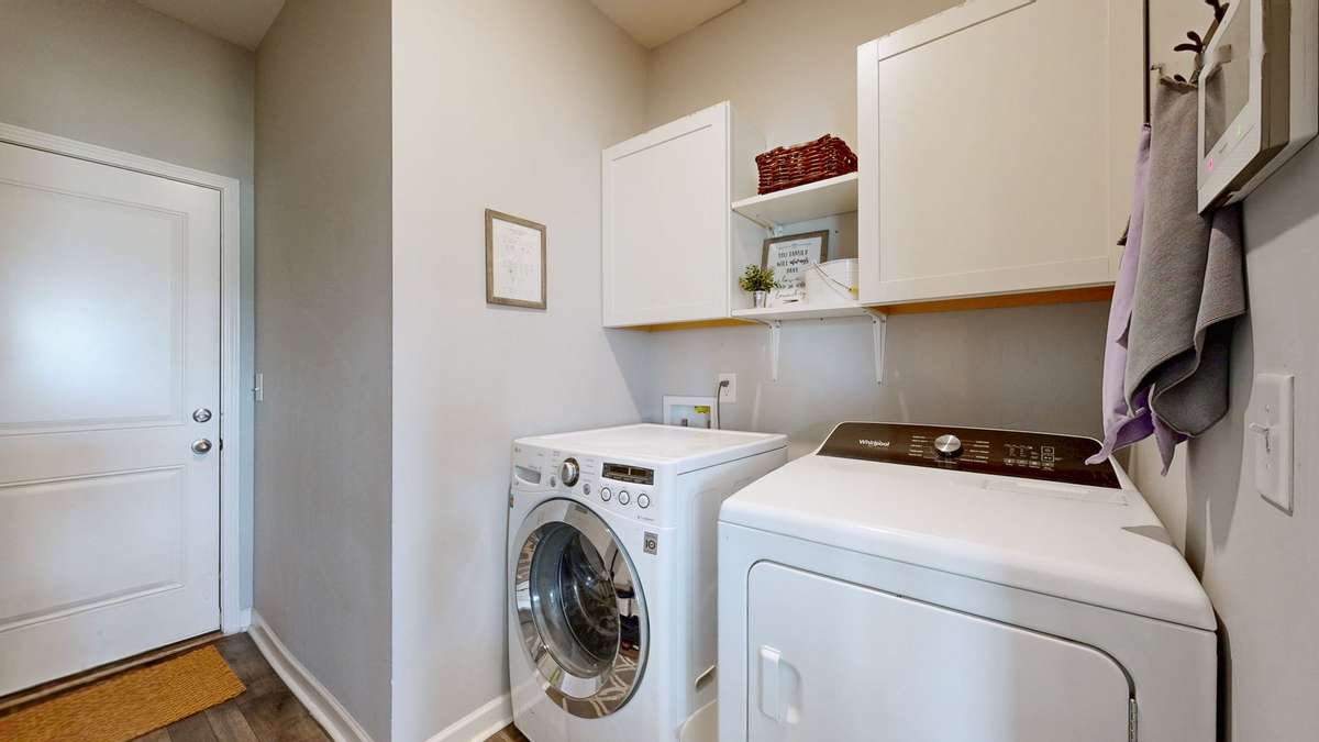 Laundry room and entry into the garage. Easily accessible from the primary suite.