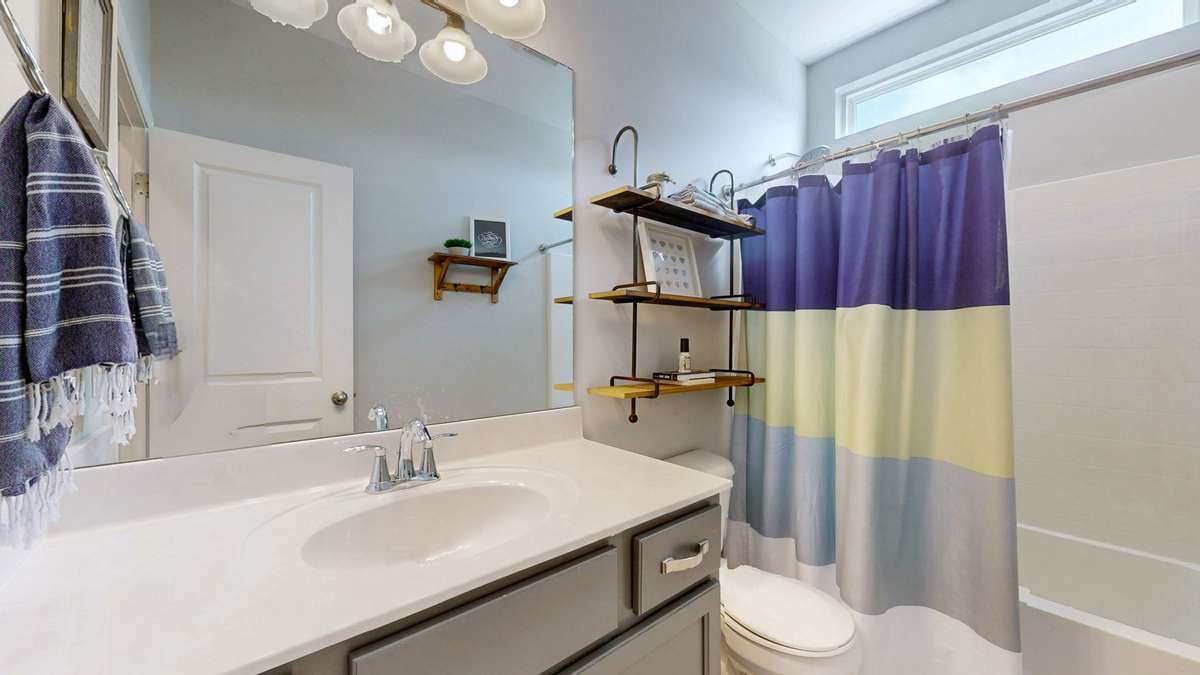 Guest bath main floor servicing the 2nd and 3rd bedrooms.
