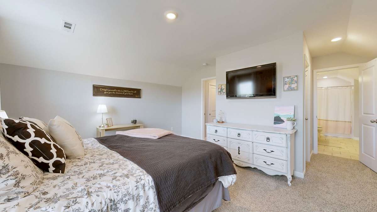 View of the bedroom entry and attached full bath.