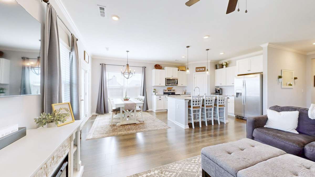 View of kitchen and dining area across from the living area.