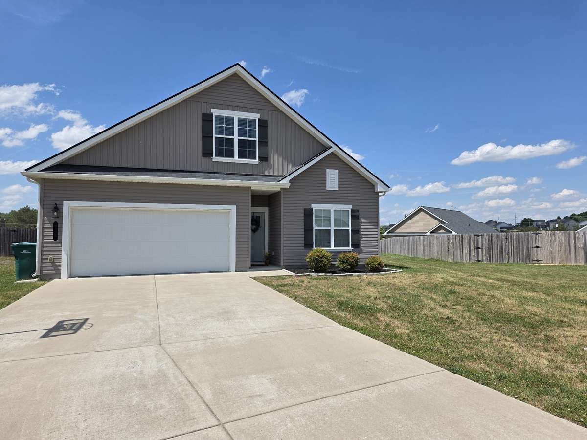 Large concrete driveway perfect for a game of basketball or additional parking for guests!