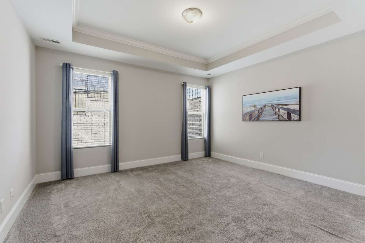 The main-level primary suite offers a luxurious bath with a garden tub, a walk-in shower, and a spacious closet