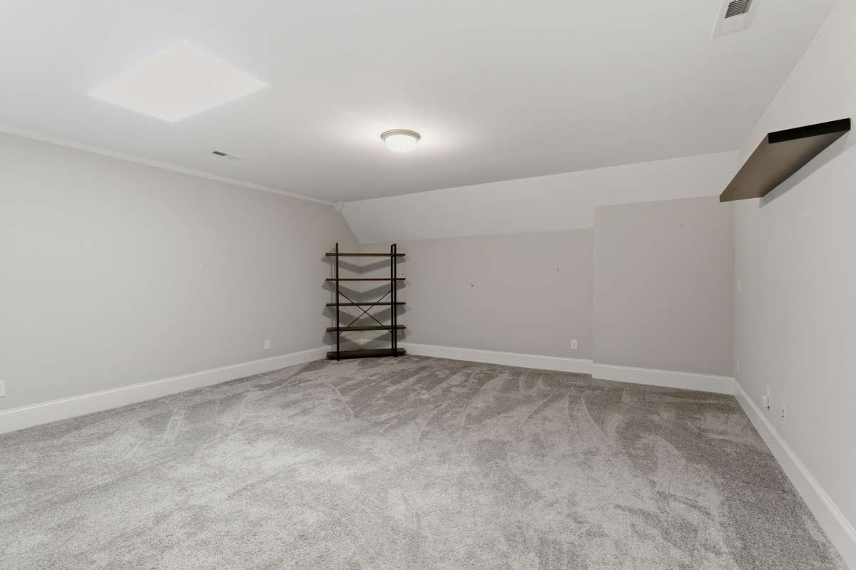 The bonus room with a skylight offers flexible space (possible 3rd bedroom or office).