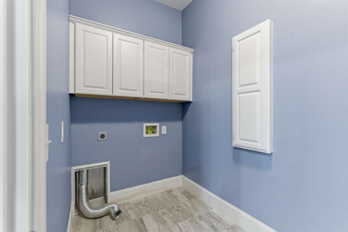 Laundry room featuring additional cabinets for extra storage.