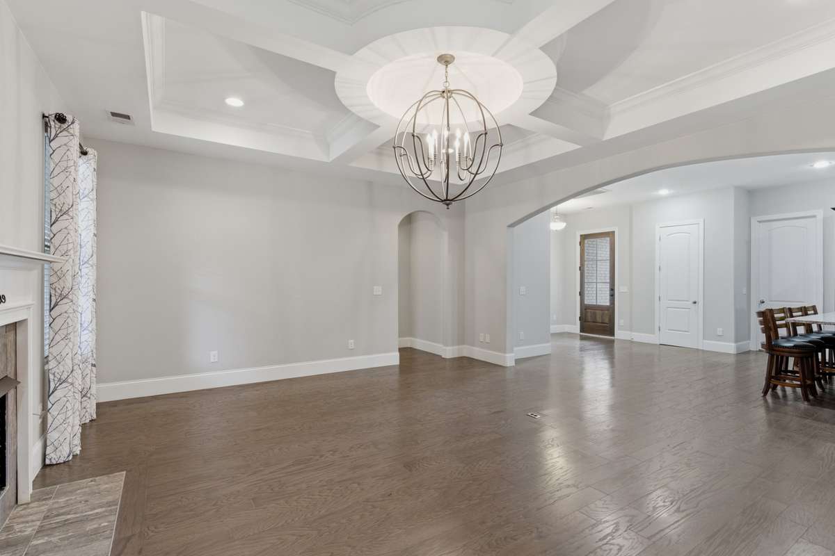 View of the living room and kitchen seen from the stairs leading to the bonus room.