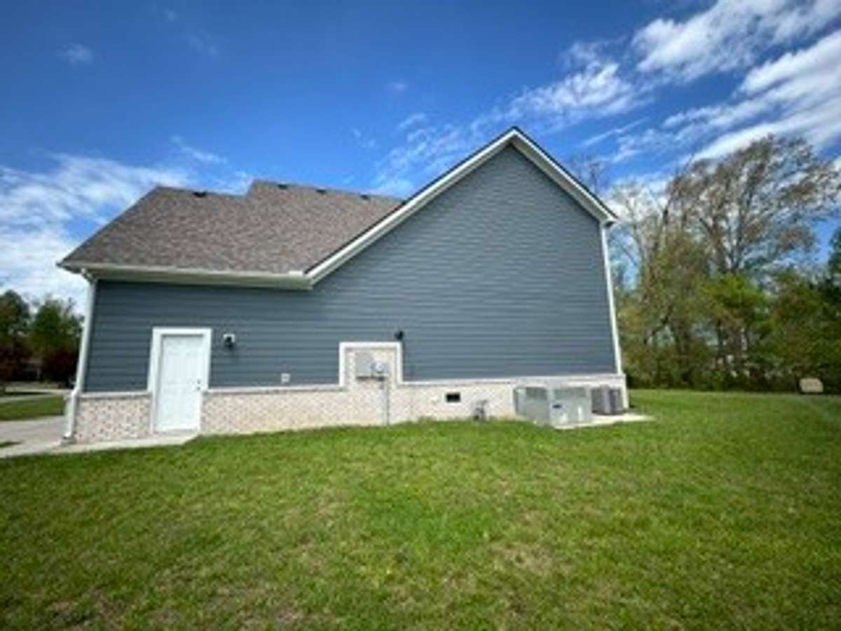Side view with Pedestrian door to garage. HVAC units only 4.5 years old. Roof 4.5 Years old.
