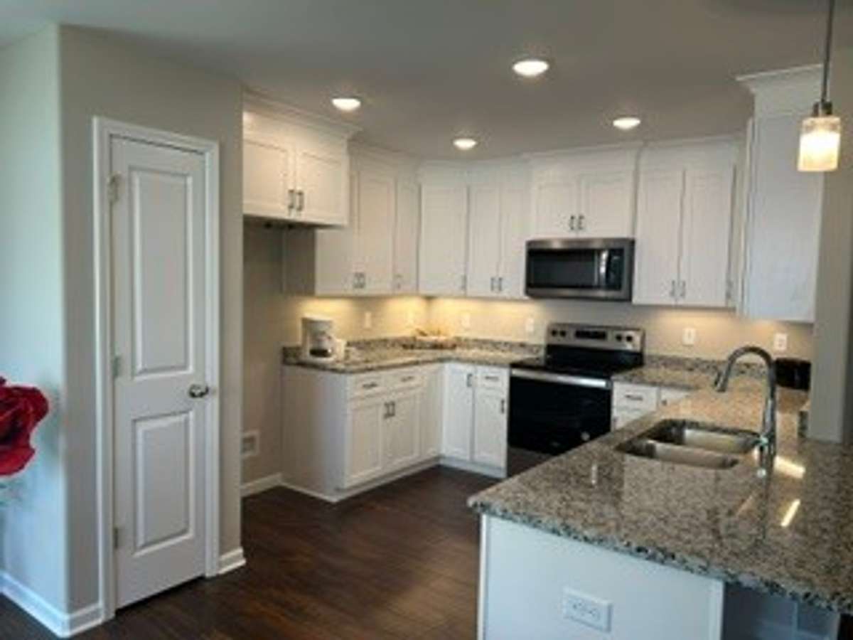 Lot of kitchen cabinets.  Vinyl plank in Kitchen. Beautiful granite counter tops.  Under counter lighting.   Pantry in kitchen.