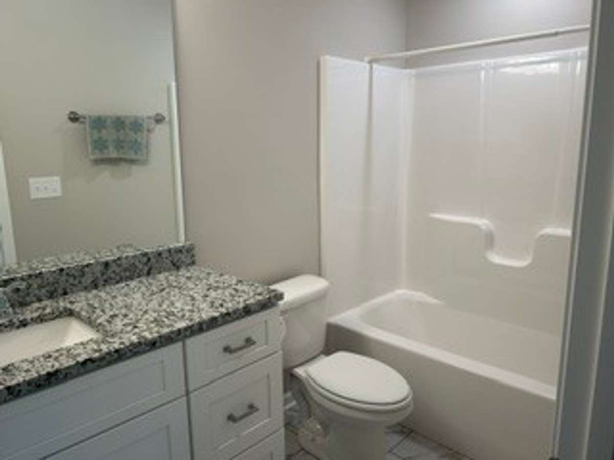 2nd bathroom upstairs with granite countertop and bath tub