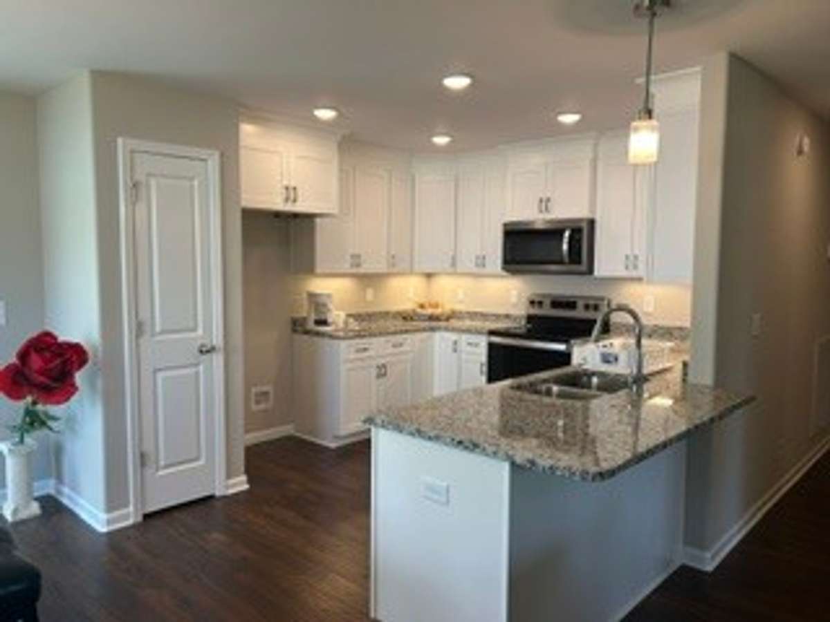 Overhang countertop fits bar stools. You can eat at counter.