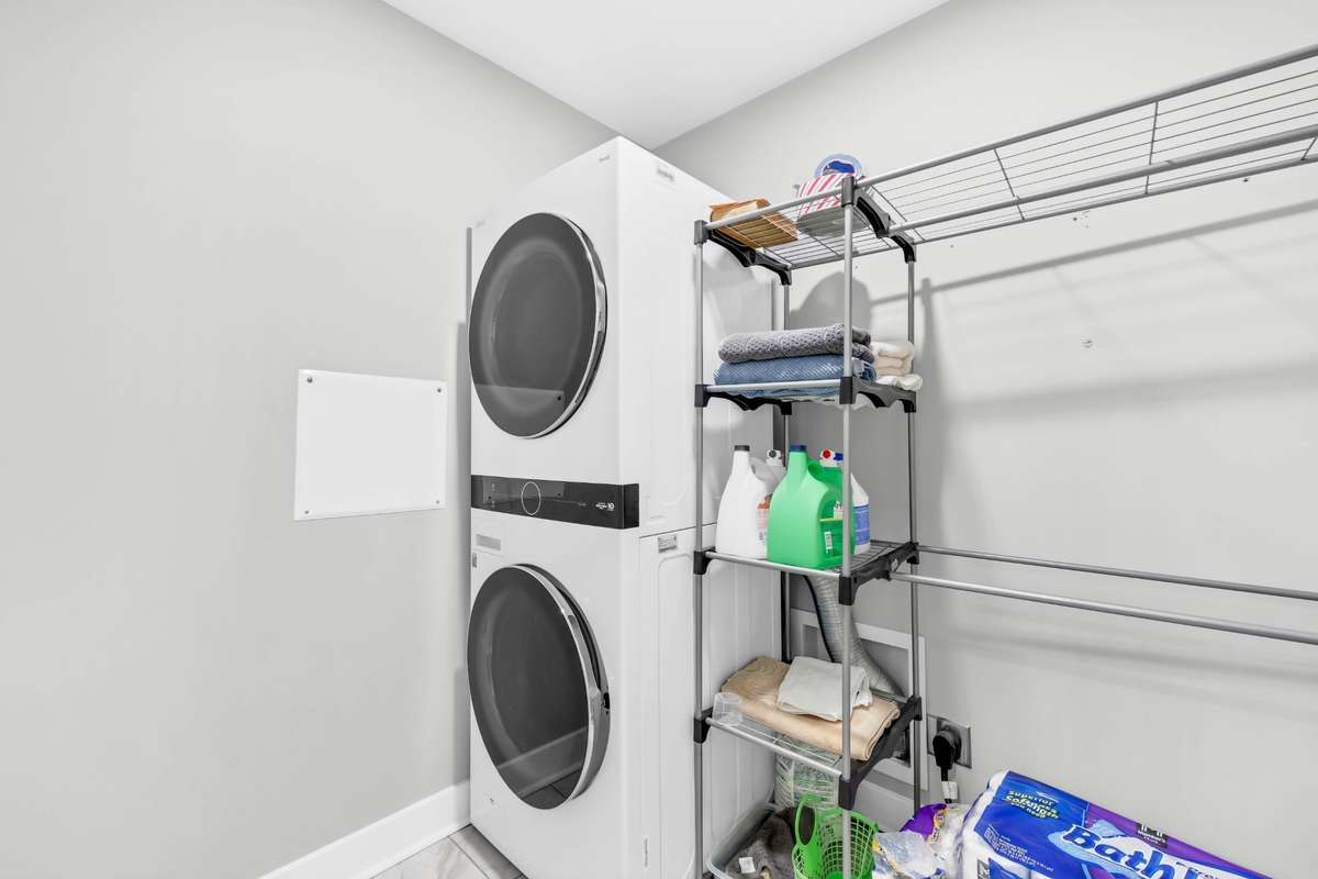 Spacious laundry area offers room for additional storage cabinets or countertop space, and the washer and dryer remain.