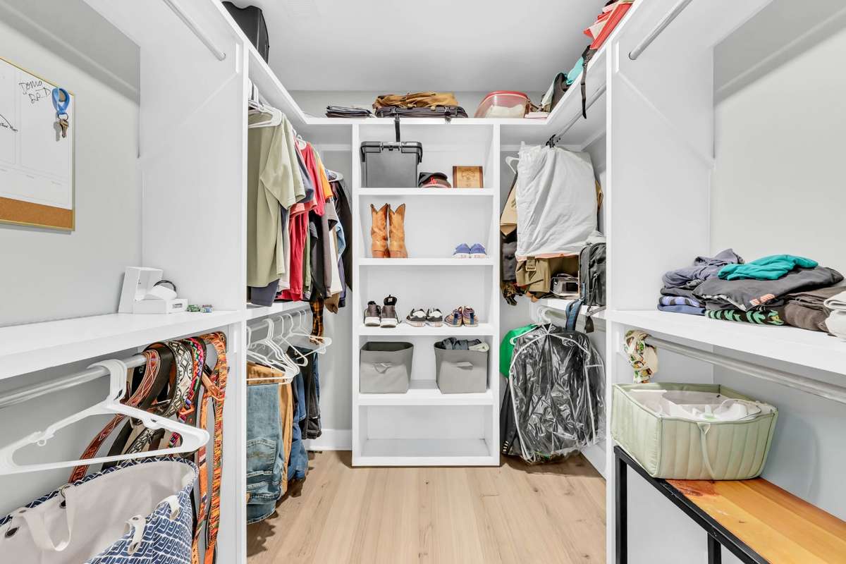 The closet includes custom built-ins designed for easy organization