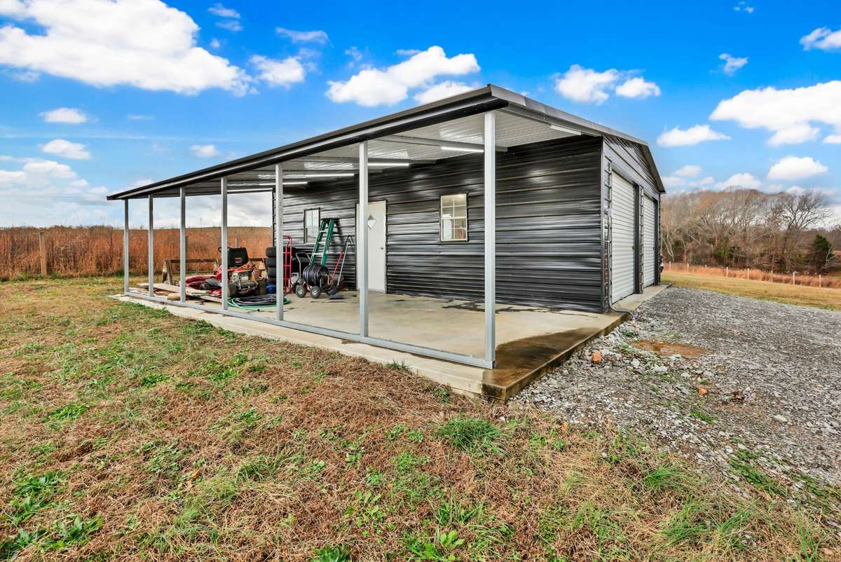 Detached shop/garage equipped with electricity for hobbies, storage, or workspace needs.