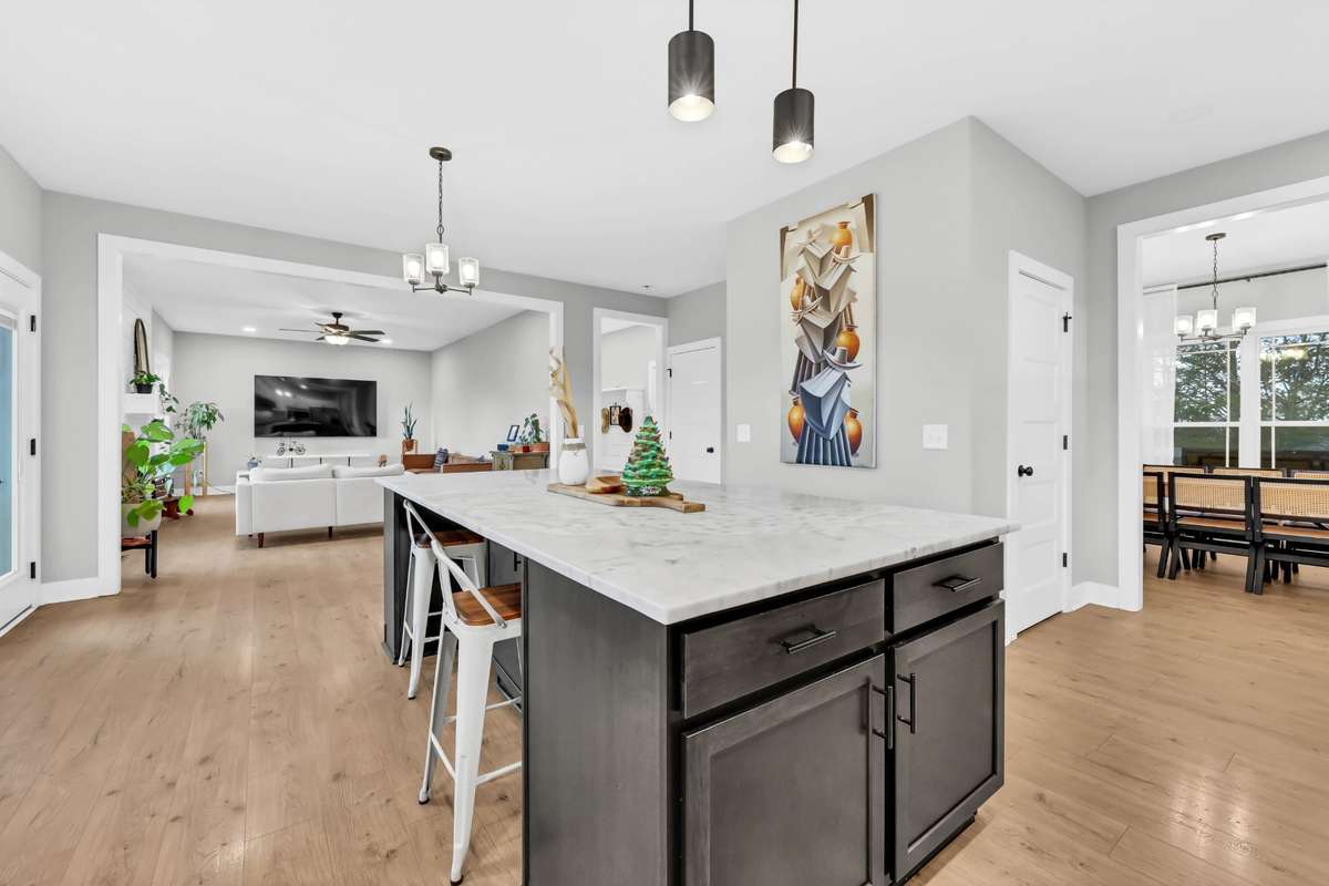 This kitchen offers an abundance of storage with a spacious pantry and additional cabinetry built into the island.