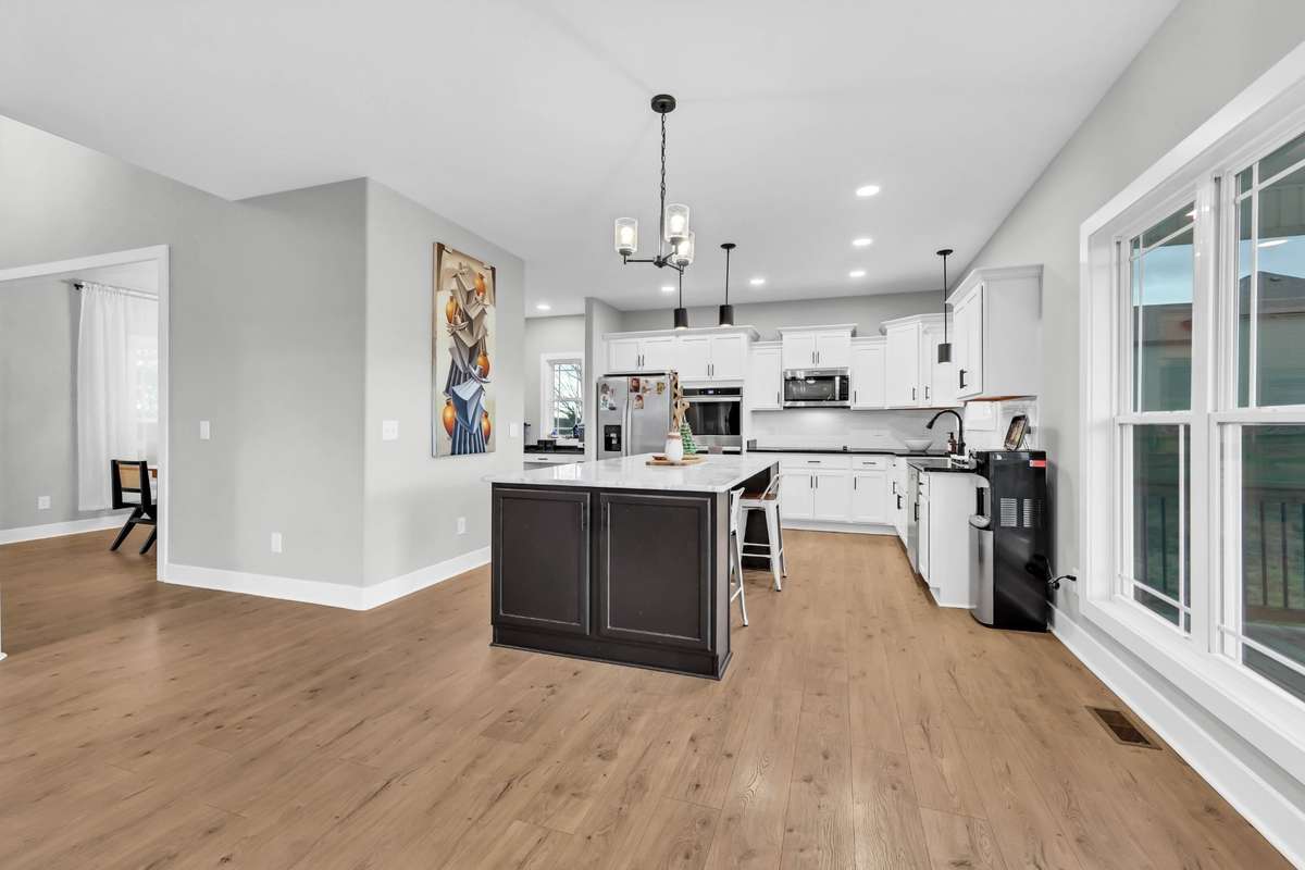 Gorgeous wood flooring thru main level- Kitchen with Granite countertops - stainless appliances & tile backsplash