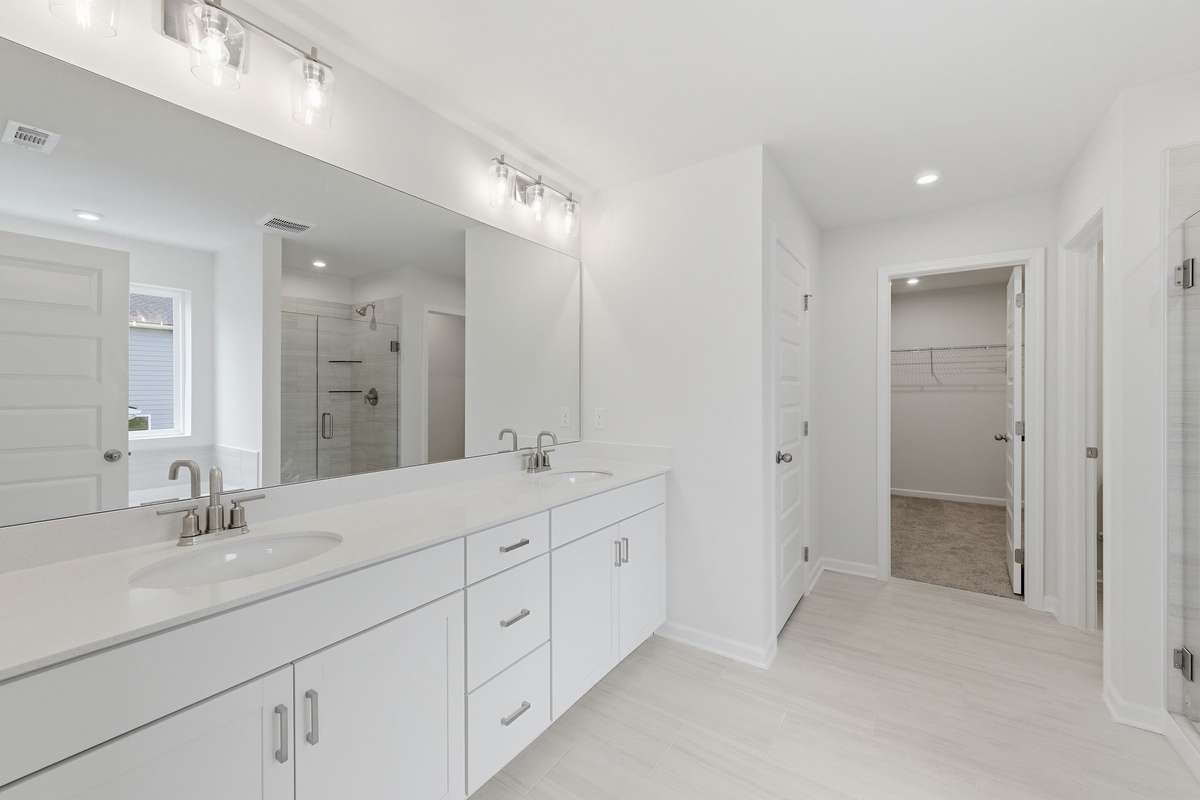 Quartz countertops and dual sinks in the Primary bathroom.