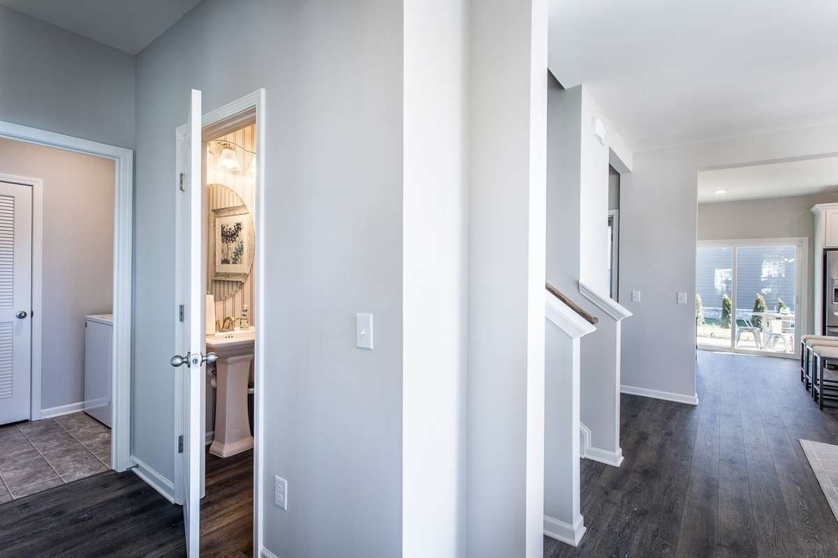 Laundry room & powder room downstairs. *All photos are of previous model home*