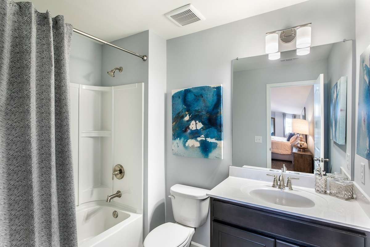 Full bathroom included when dual primary suite (5th bedroom/3rd bathroom) option added upstairs! *All photos are of previous model home*