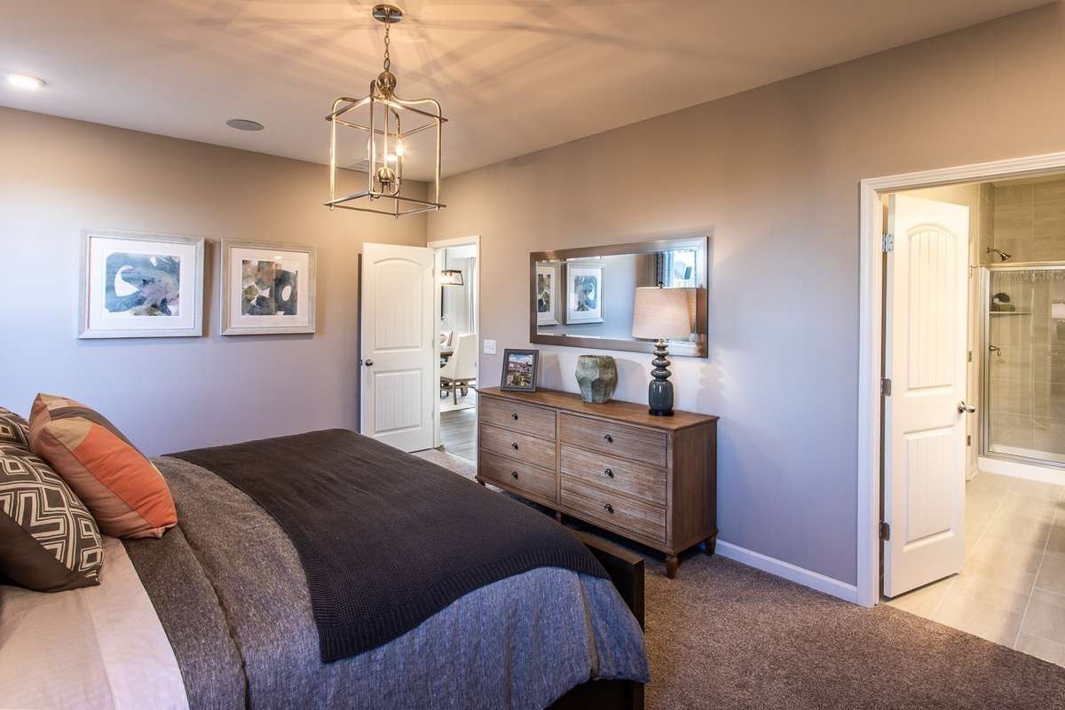 Oversized primary suite downstairs! King size furnishings shown. *All photos are of previous model home*
