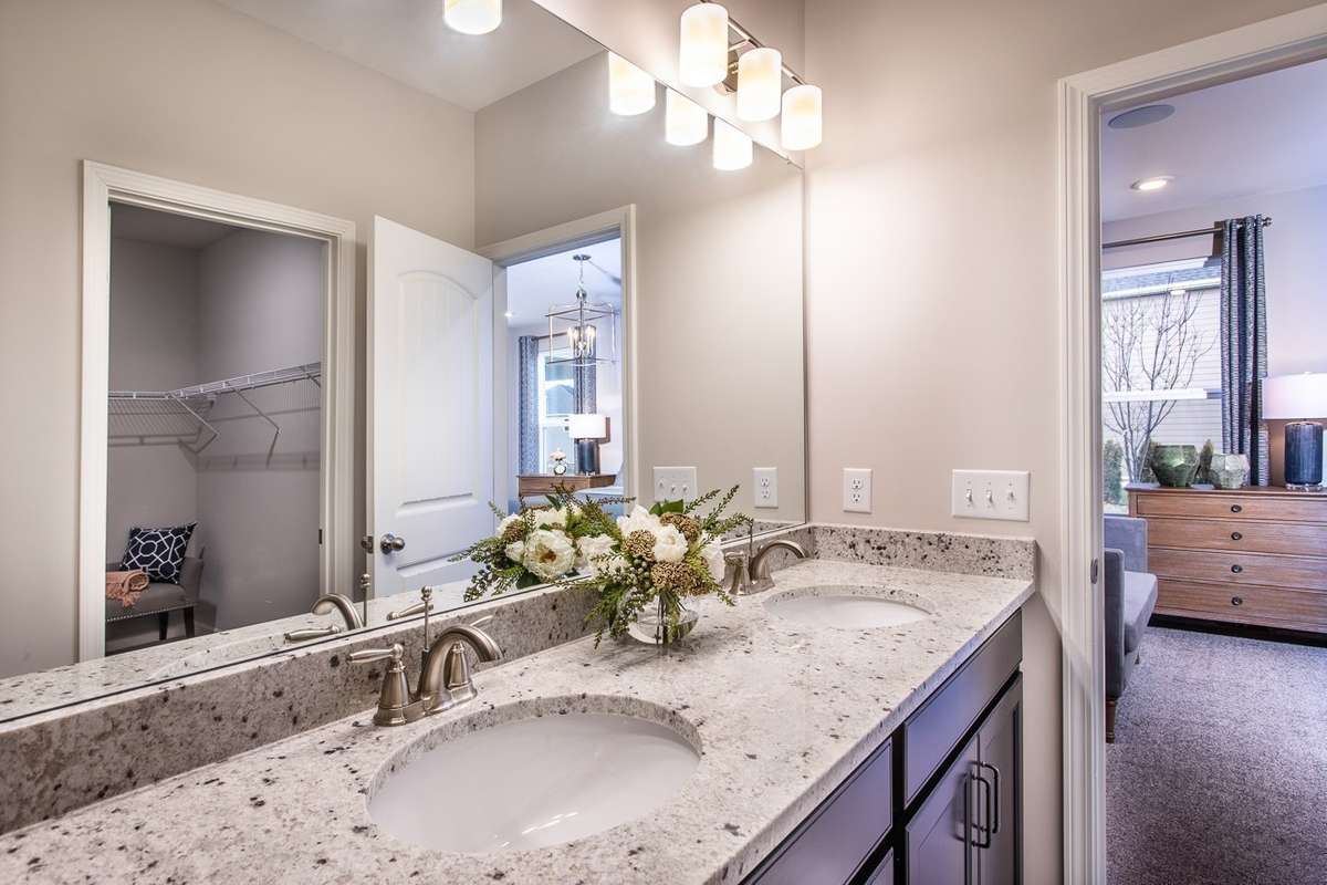 Double vanities in your primary suite with large walk-in closet. Quartz countertops included. *All photos are of previous model home*