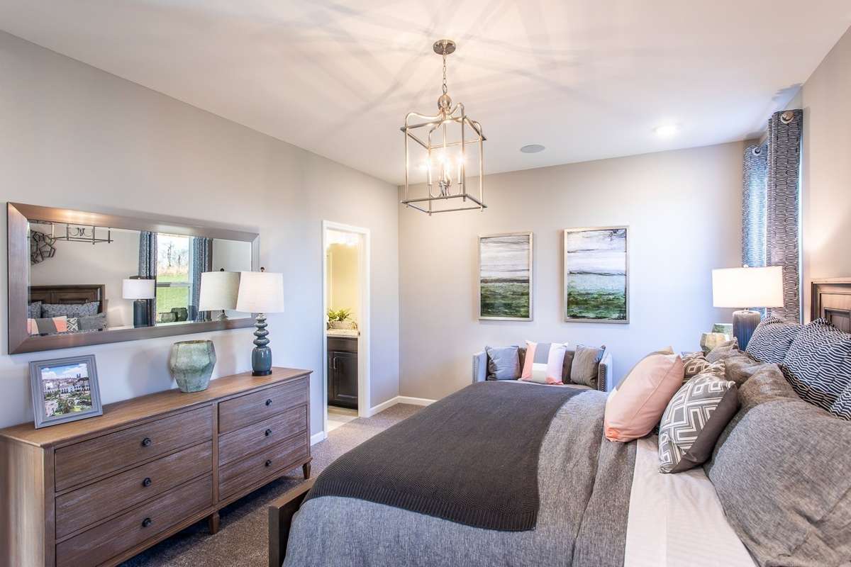 Oversized primary suite downstairs! King size furnishings shown. *All photos are of previous model home*