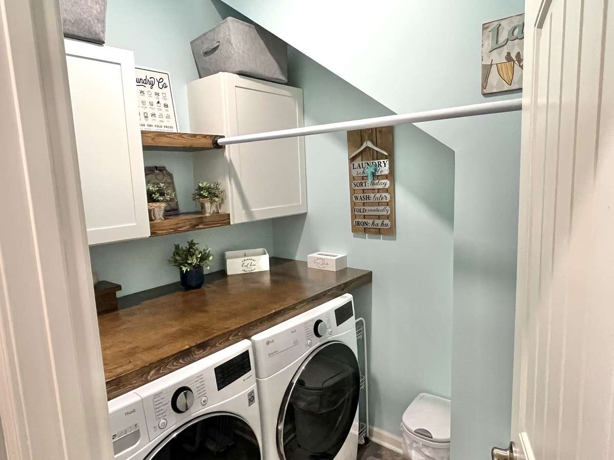 A real laundry room with custom cabinet/shelves/folding table