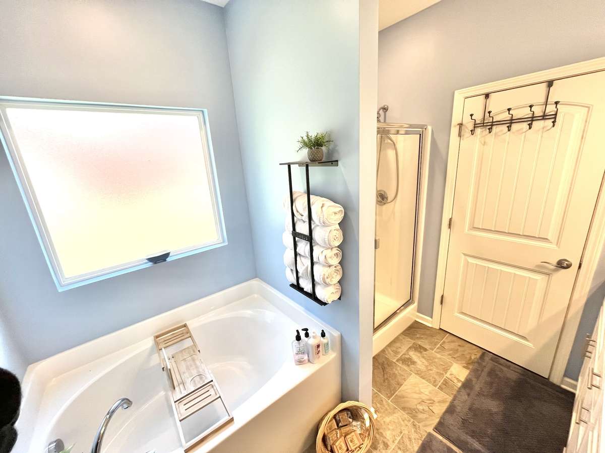 Soak away the day and dream of the ocean. Serparate shower in easy to clean fiberglass. Great looking tile floors