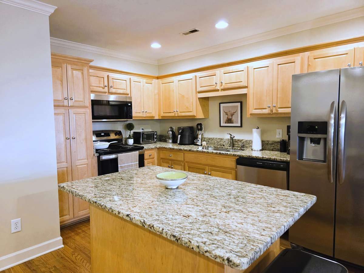 Kitchen with all SS appliances, island provides great prep area and casual dining spot.