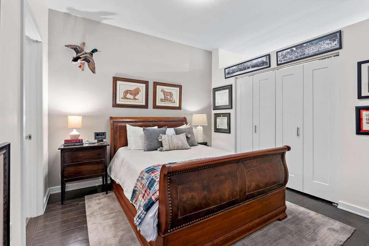 Private primary bedroom suite with wood floors