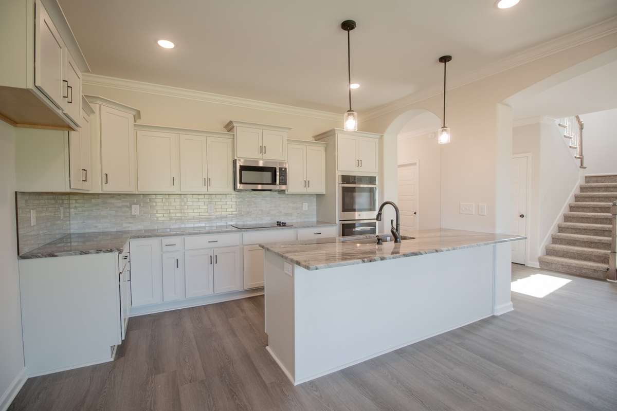 EXAMPLE>>> Large Kitchen Features a SMART Double Oven, Granite Countertops, Tile Backsplash, Recessed Lighting, Large Island and Lots of Cabinetry!!
