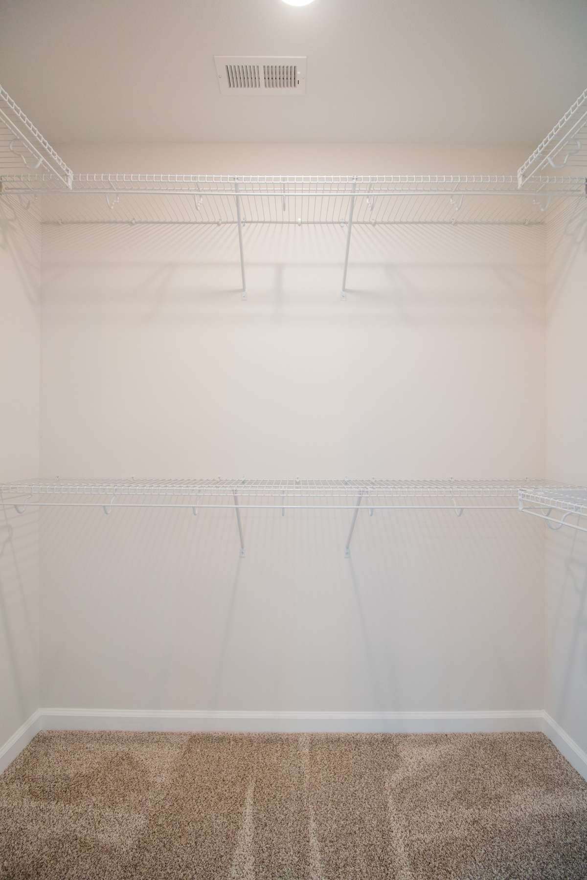 EXAMPLE>>> One of Two Walk-in Closets with Tons of Shelving and a Shoe Rack! (Primary Bedroom)
