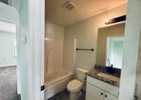 Upstairs hall bath features granite countertops and tile finishes, offering both style and durability.