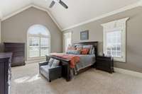 The primary suite has a vaulted ceiling, several windows for natural light, and 2 separate closets!